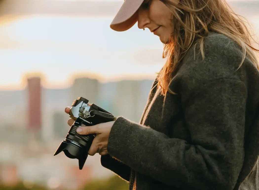 Girl looking at a photo on the camera screen.