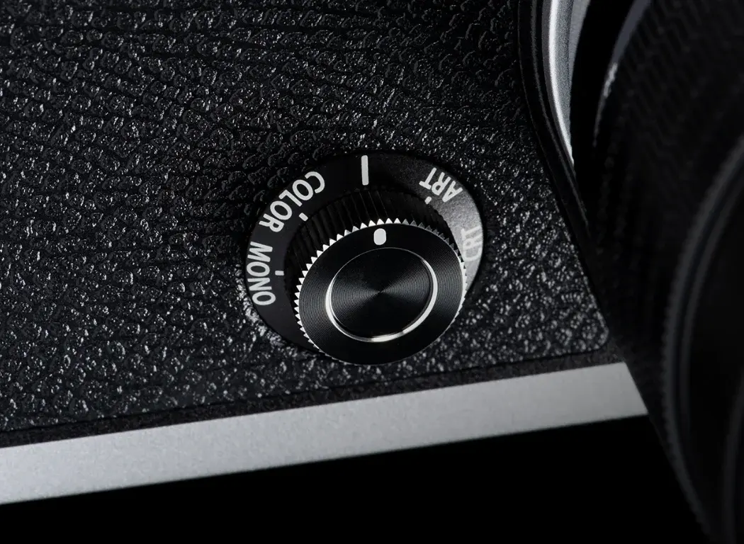 OM SYSTEM OM-3 creative dial on the front of the camera body.