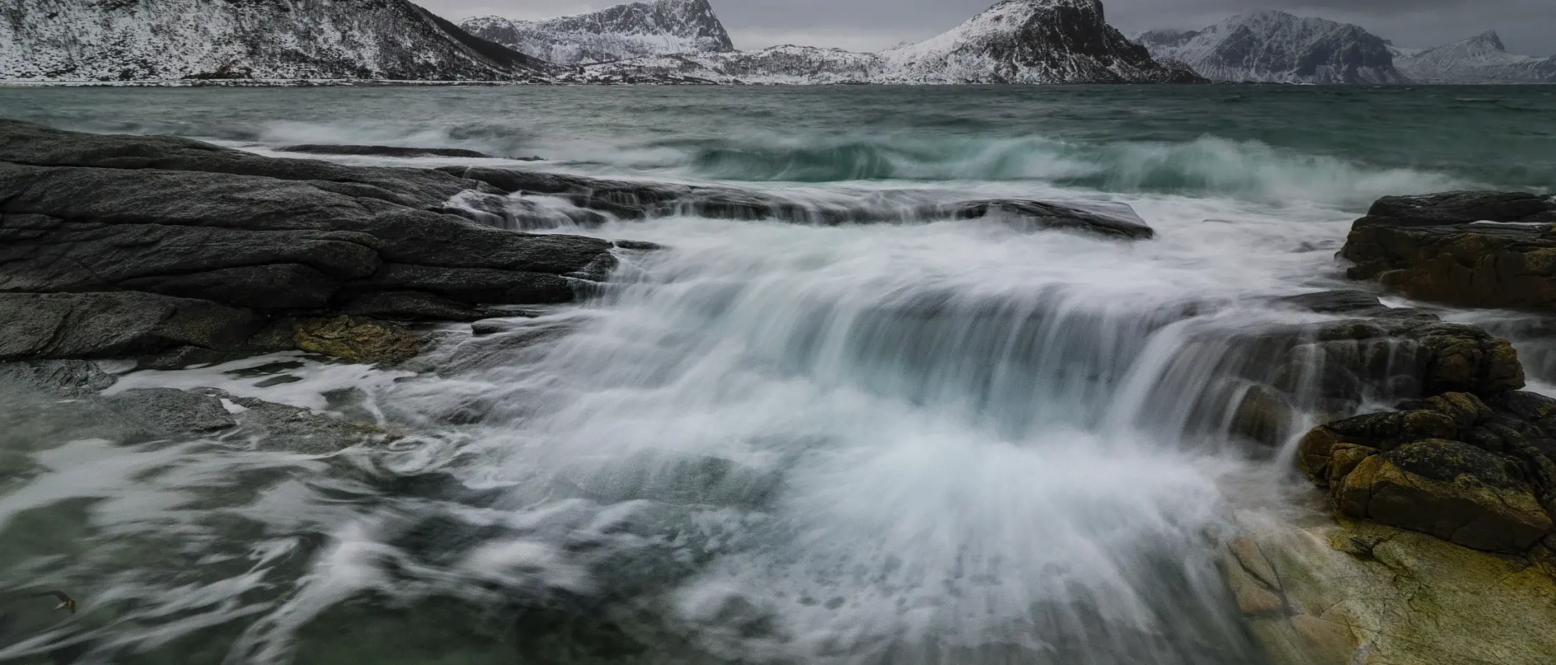 Short waterfall with water spilling over using a long shutter to create creamy water affect, shot with the OM SYSTEM OM-3.